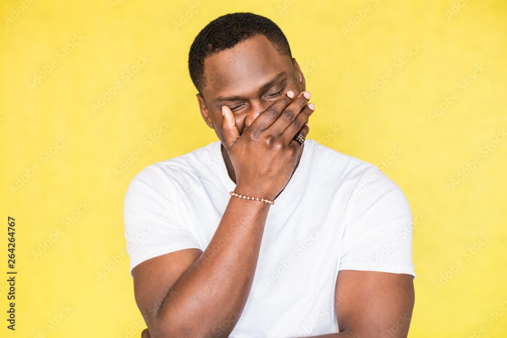 African American man covered his face with his hand African American man covered his face with his hand