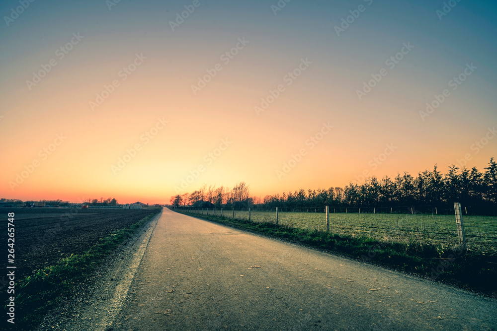 Road to a sunset in a rural environment