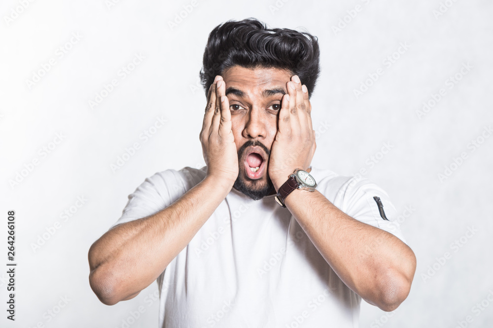 Amazed young man looks with horror and panic, being shocked to hear bad news. Amazed young man looks with horror and panic, being shocked to hear bad news.