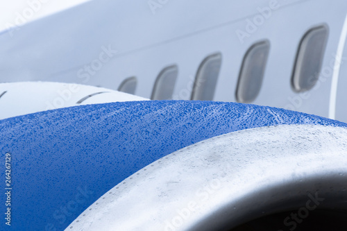 View of the engine of the aircraft, raindrops on a wet surface. photo