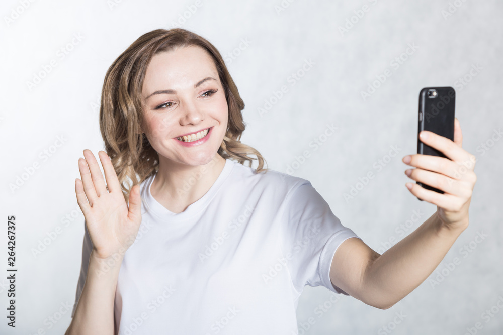Beautiful young woman taking selfie on smartphone. Beautiful young woman taking selfie on smartphone.
