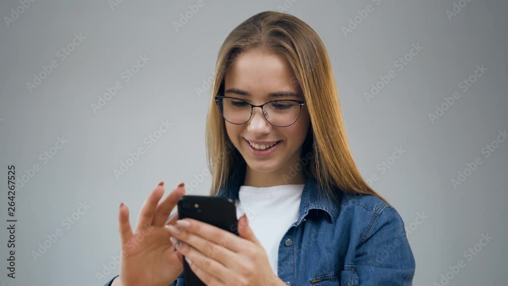 Beautiful young woman using smart phone in the office. Beautiful young woman using smart phone in the office.