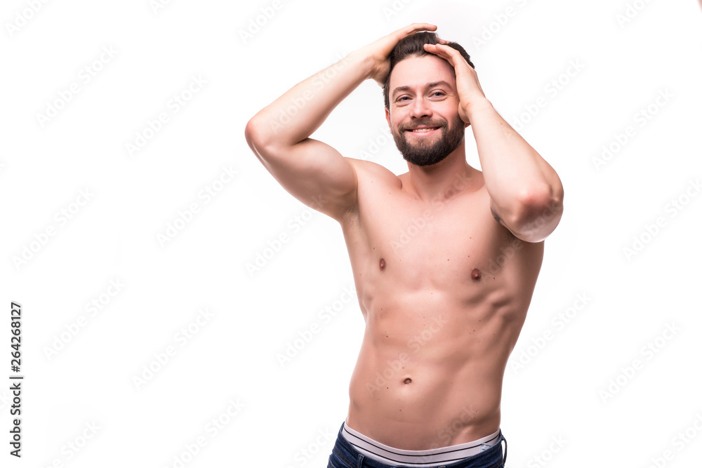 Fototapeta premium Portrait of a well built shirtless muscular man against white background