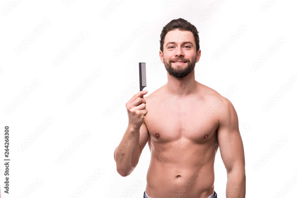 Close up portrait of satisfied glad excited cheerful virile masculine muscular bearded with toothy smile handsome guy demonstrating comb isolated on gray background Close up portrait of satisfied glad excited cheerful virile masculine muscular bearded with toothy smile handsome guy demonstrating comb isolated on gray background