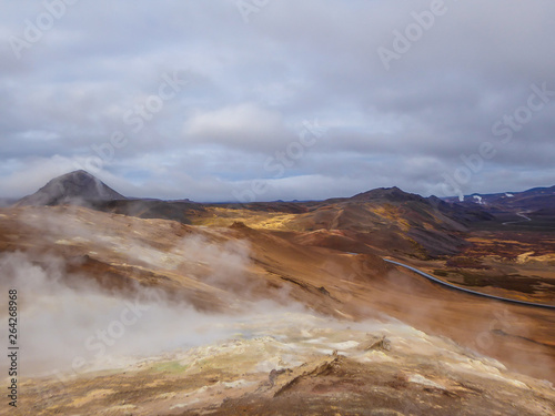Smoking pools, filled with sulfur seen from above. Thick and dense smoke surrounding the whole area. Geothermal activity region in Iceland, Hverir. Place where you feel the power of the planet.