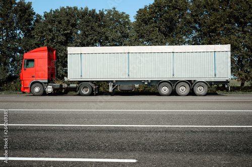 Truck is going along the road. Cargo transportation concept.
