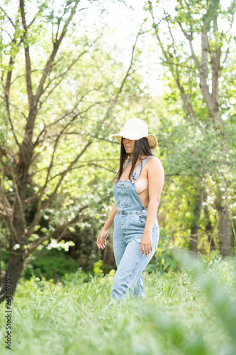 Young woman posing in countryside with hat © davidaguerophoto