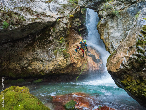 Abseiling over waterfall photo