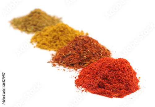 Four piles of spices.