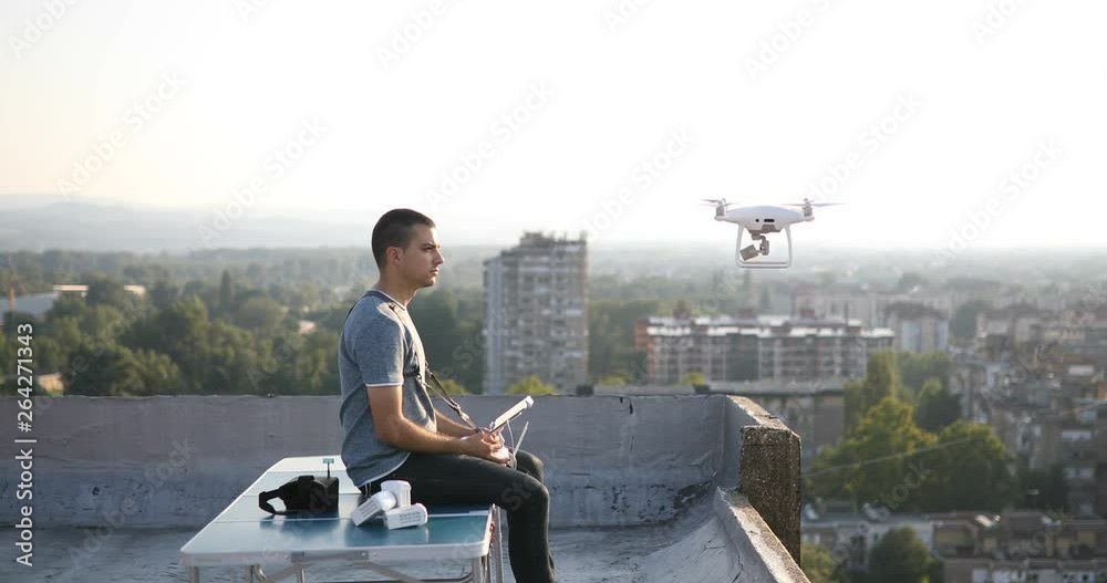 Man with drone flying at the city. Aerial cityscape drone view