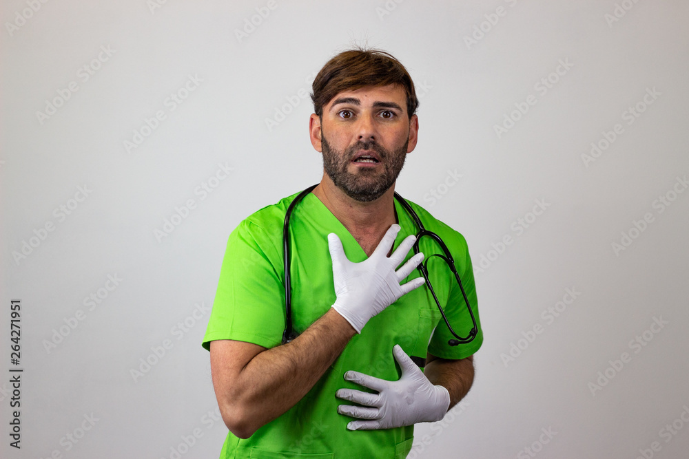Portrait of male veterinary doctor in green uniform with brown hair anxiusly, their back facing the camera and looking at the camera. Isolated on white background.