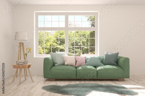 Stylish room in white color with sofa and summer landscape in window. Scandinavian interior design. 3D illustration © AntonSh