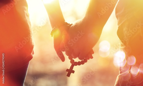 Couple praying together. Ho...