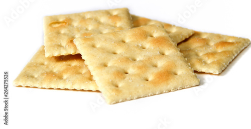 Eye level view of small stack of saltine or soup crackers, also known as soda crackers over white. photo
