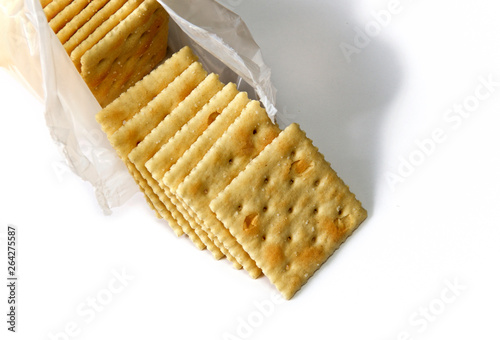 Photography Opened package of saltine crackers also known as soup and soda crackers over white, not isolated