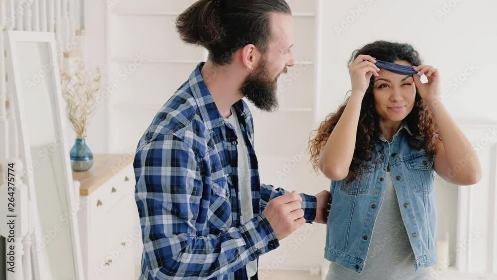 Young couple moving into new home. Life changing experience. Hipster guy surprised his gf with new apartment. Young couple moving into new home. Life changing experience. Hipster guy surprised his gf with new apartment.