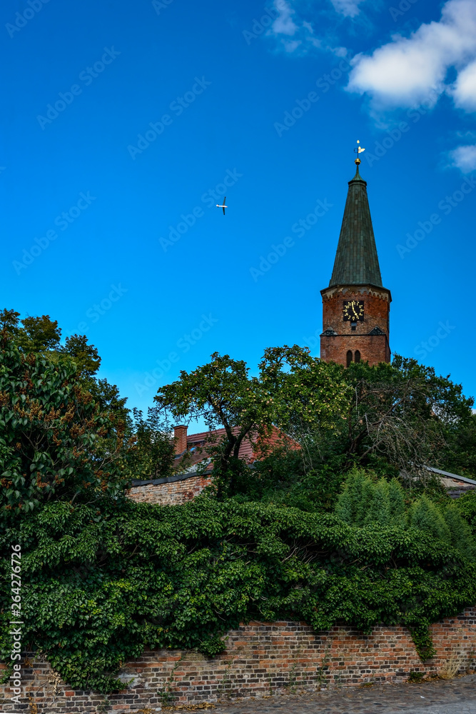 Blick vom Domkietz auf den Turm des Doms St. Peter und Paul in Brandenburg an der Havel, am Himmel ein Flugzeug Blick vom Domkietz auf den Turm des Doms St. Peter und Paul in Brandenburg an der Havel, am Himmel ein Flugzeug