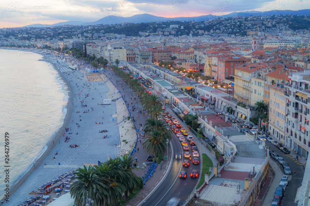 A colorful sunset with a beautiful view over the beach of Nice and his city