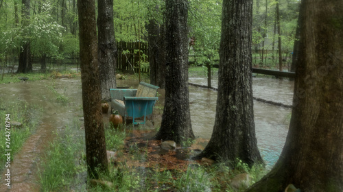 Stream overflowing and flooding yard after a rainstorm