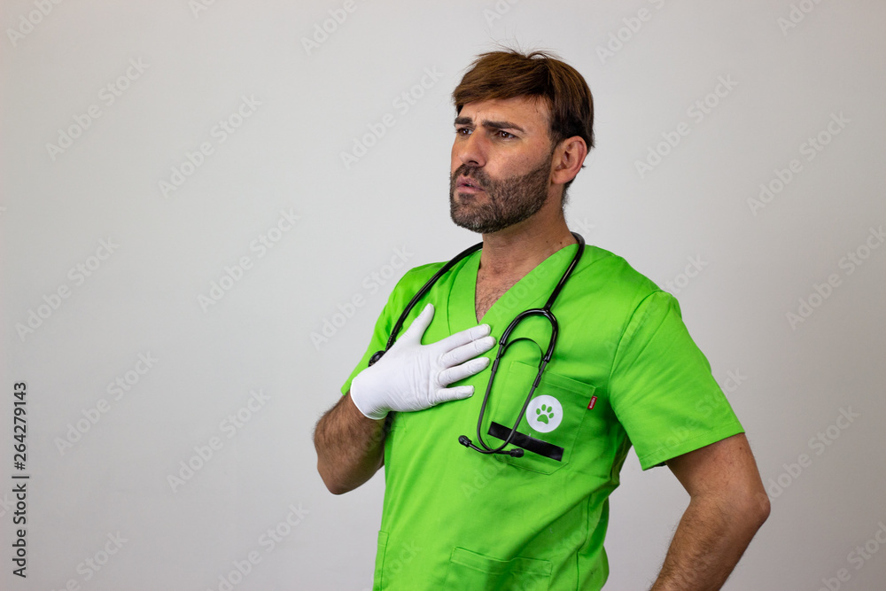 Portrait of male veterinary doctor in green uniform with brown hair with remorse, facing forwards and looking at the horizon. Isolated on white background. Portrait of male veterinary doctor in green uniform with brown hair with remorse, facing forwards and looking at the horizon. Isolated on white background.