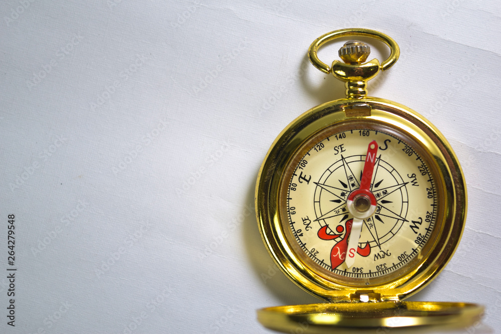 Close up magnetic golden compass isolated on white background. Close up magnetic golden compass isolated on white background.