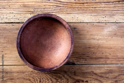 Ceramic bowl on wooden background