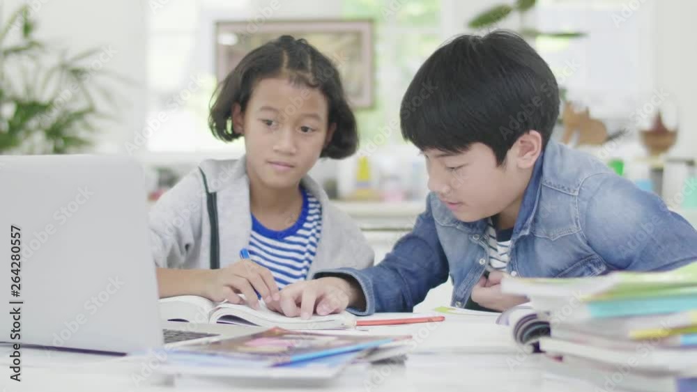 Young boys are using computers to teach and explain homework. To friends with facial expressions and happy gestures, Dolly shoot 60fps. Young boys are using computers to teach and explain homework. To friends with facial expressions and happy gestures, Dolly shoot 60fps.