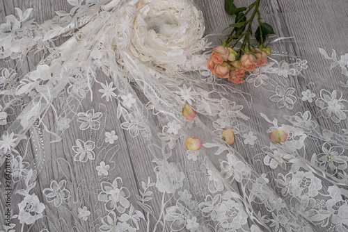 The texture of lace on wooden background decoreted roses. photo