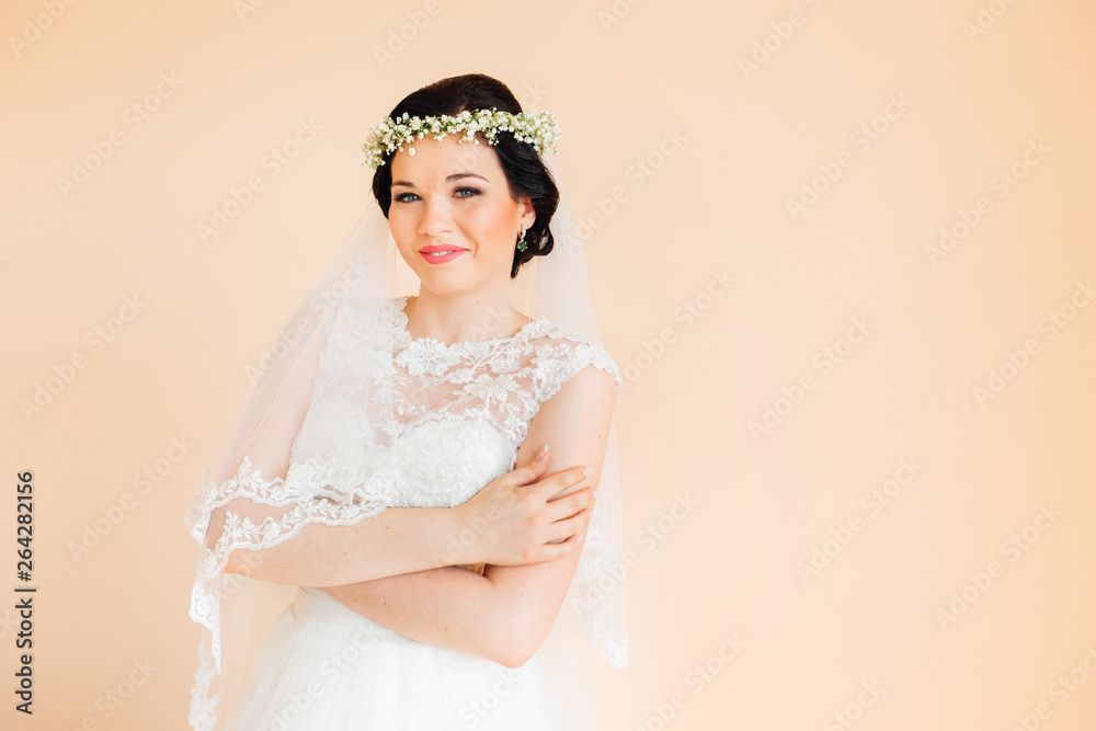 Bride in beautiful dress closed her eyes and holding hands on wa Bride in beautiful dress closed her eyes and holding hands on wa