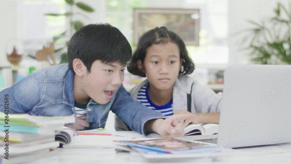 Young boys are using computers to teach and explain homework. To friends with facial expressions and happy gestures, Dolly shoot 60fps. Young boys are using computers to teach and explain homework. To friends with facial expressions and happy gestures, Dolly shoot 60fps.
