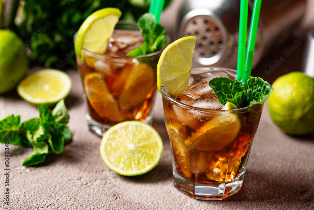 Cuba libre cocktail with mint and lime Cuba libre cocktail with mint and lime