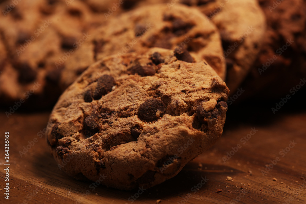 Fototapeta premium Chocolate cookies on wooden table. Chocolate chip cookies