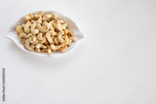 cashew nuts in a bowl isolated on white background