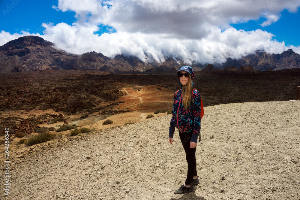 Girl is hiking among  volcano nature park