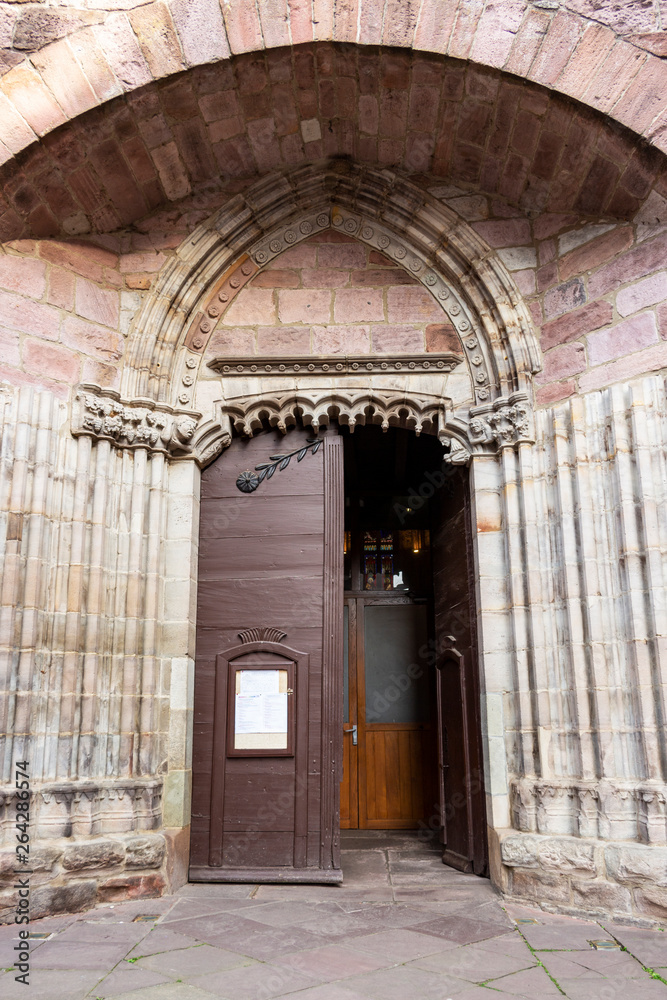 Entrance door of Notre-Dame-du-Bout-du-Pont Church in the town of Saint-Jean-Pied-de-Port, France on the Camino de Santiago, Way of St. James, architectural exterior detail
