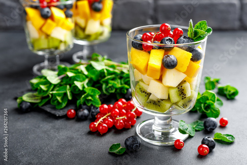 Fototapeta Naklejka Na Ścianę i Meble -  Fresh salad with fruits and berries in glass.