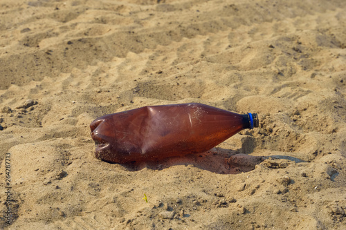 plastic bottle garbage lying of sand