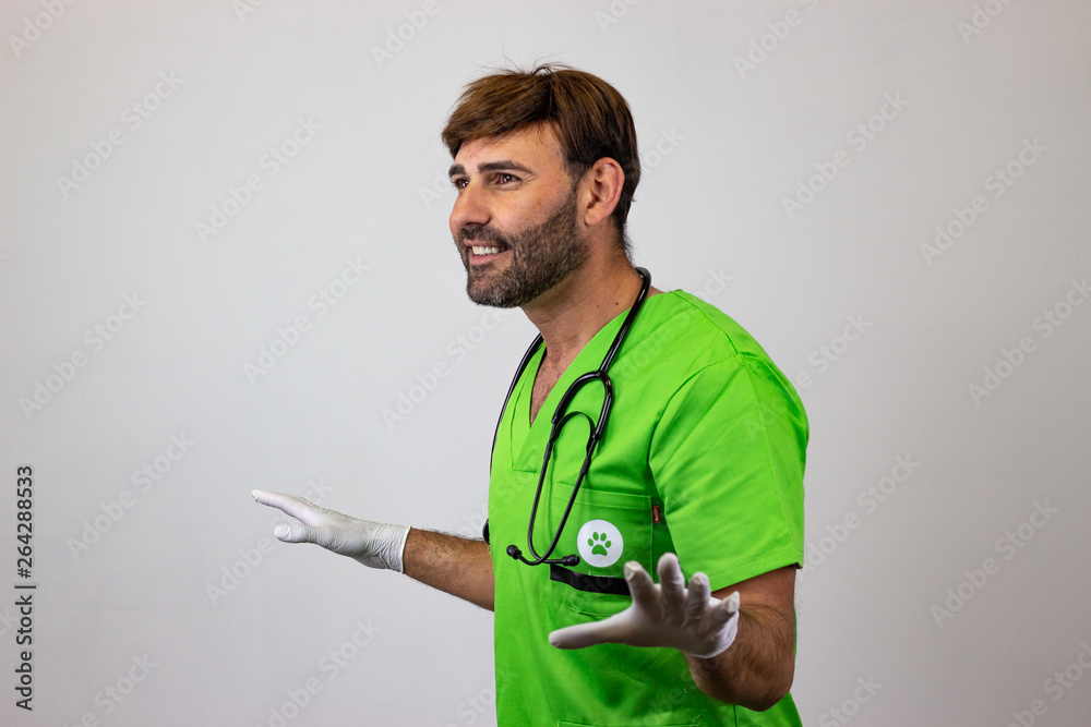 Portrait of male veterinary doctor in green uniform with brown hair and arms spread wide open, facing forwards and looking at the horizon. Isolated on white background. Portrait of male veterinary doctor in green uniform with brown hair and arms spread wide open, facing forwards and looking at the horizon. Isolated on white background.