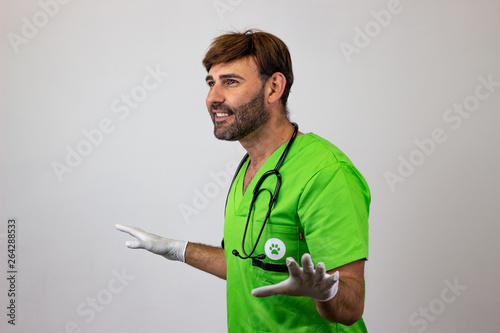 Portrait of male veterinary doctor in green uniform with brown hair and arms spread wide open, facing forwards and looking at the horizon. Isolated on white background.