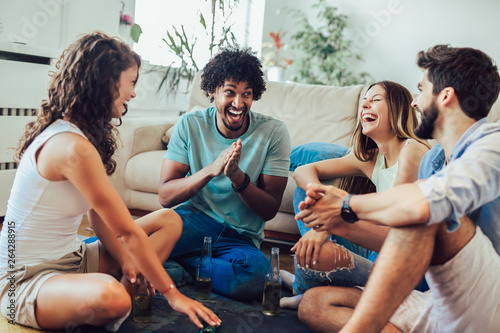 Φωτογραφία Group of young friends playing game of truth. Home party.