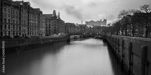Black and white long exposure of warehouse district in Hamburg with Elbphilharmonie in the background