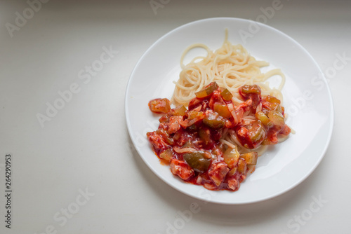 Macaroni with vegetables on a white plate