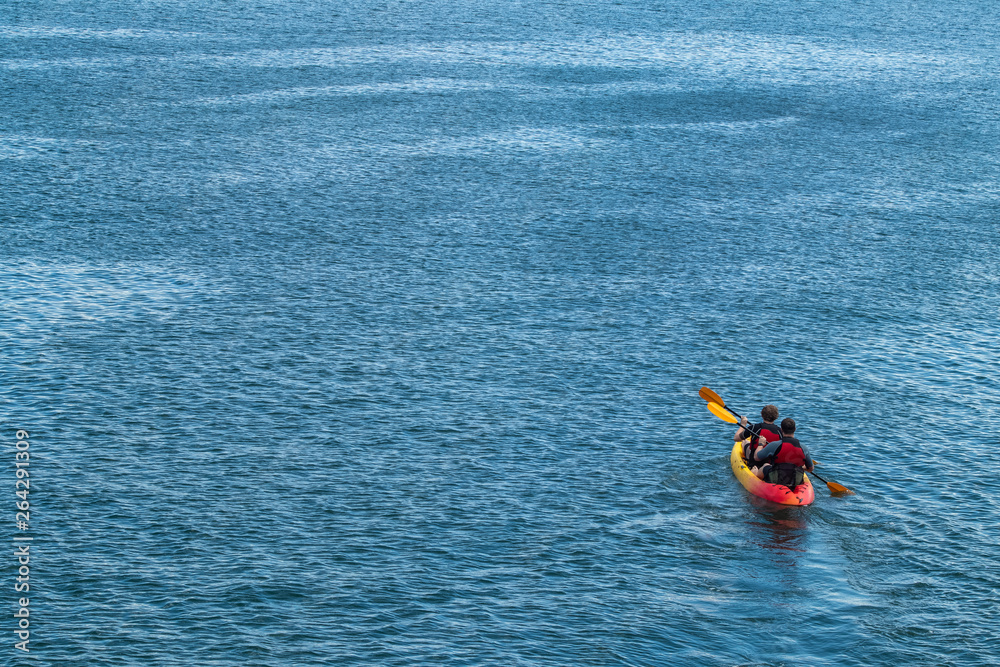 Two Men Kayaking in Open Waters