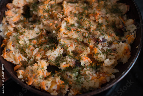 Potatoes with vegetables on a frying pan
