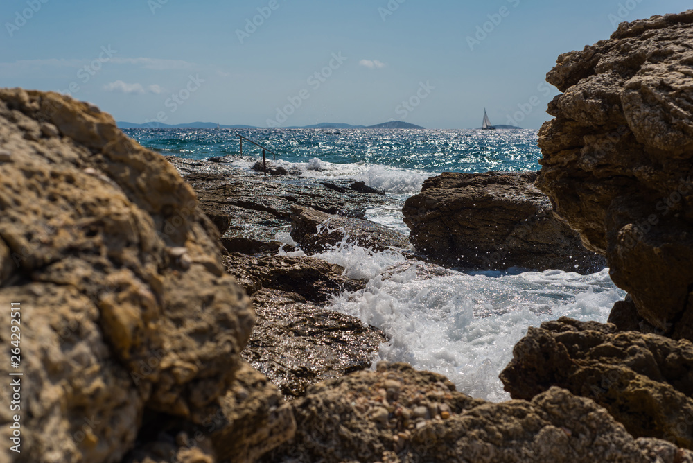 Waves breaking on a stony beach in Murter, Croatia, Dalmatia