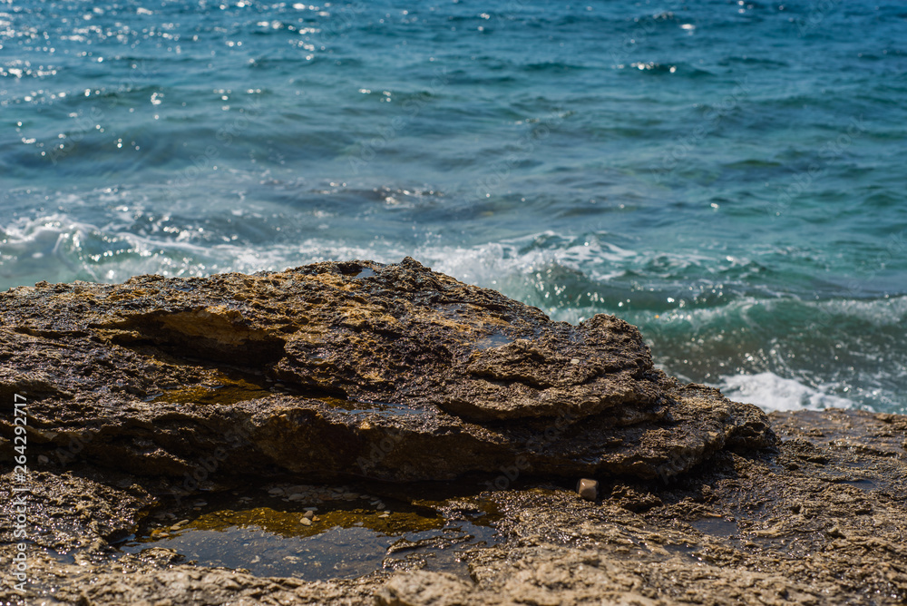 Waves breaking on a stony beach in Murter, Croatia, Dalmatia Waves breaking on a stony beach in Murter, Croatia, Dalmatia