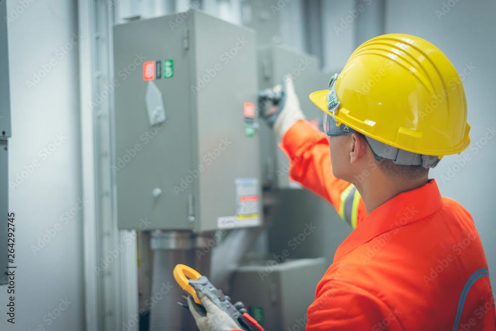 close up men working with the control cabinet close up men working with the control cabinet