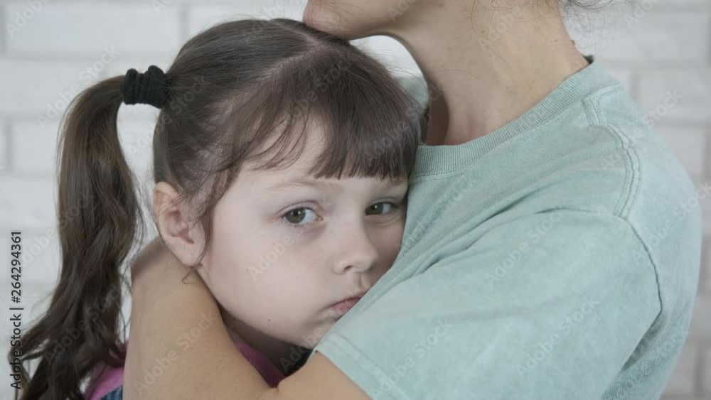 Portrait of a child in depression. Mother hugs sad little daughter. Portrait of a child in depression. Mother hugs sad little daughter.