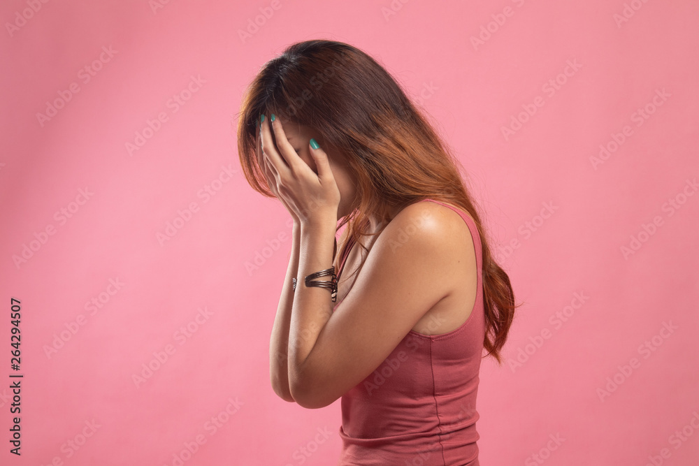 Sad young Asian woman cry with palm to face. Sad young Asian woman cry with palm to face.
