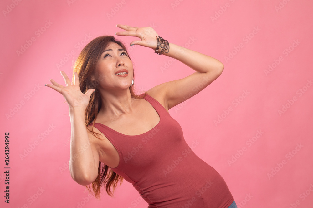 Excited young Asian woman look up. Excited young Asian woman look up.